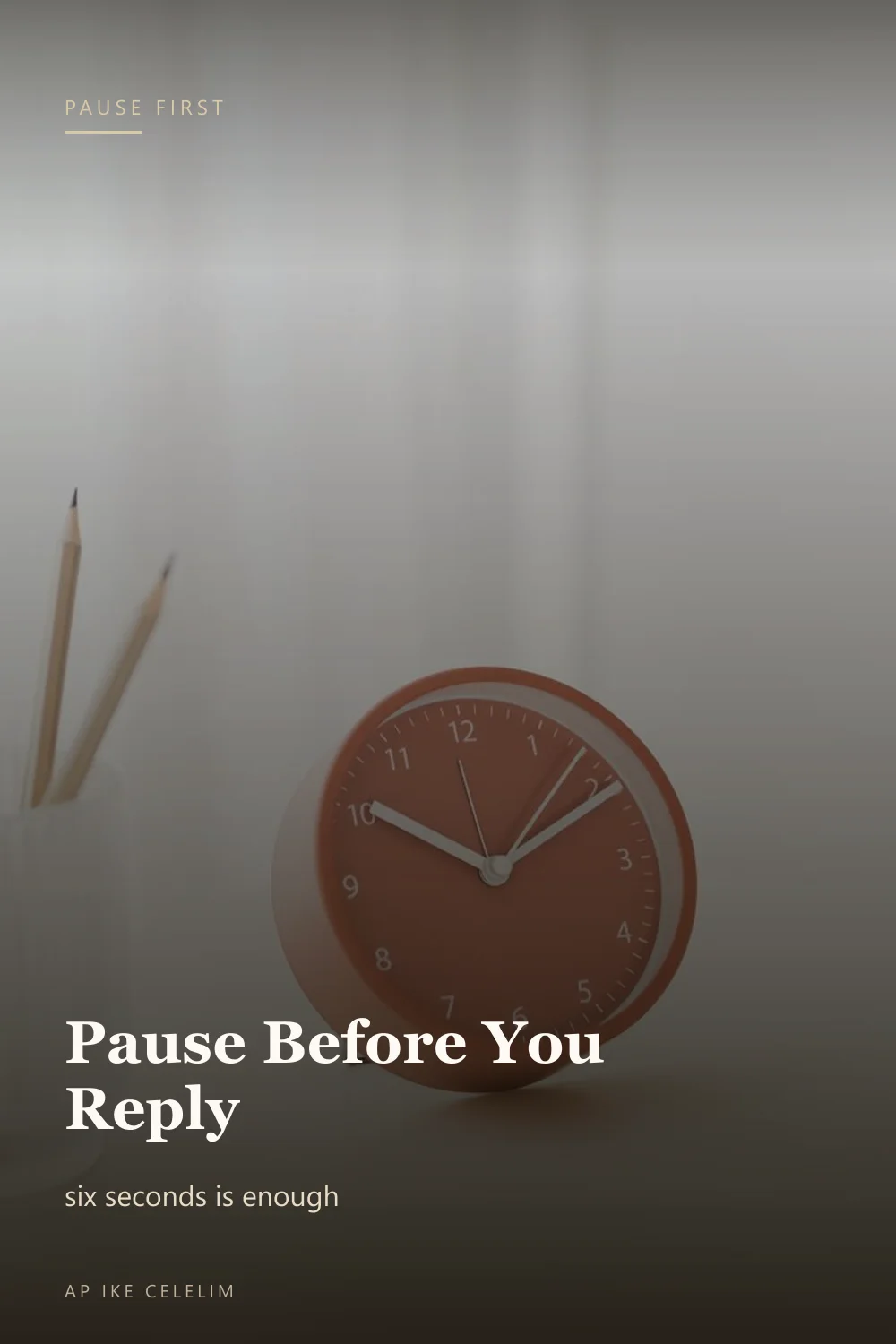 A red desk clock beside pencils on a white desk