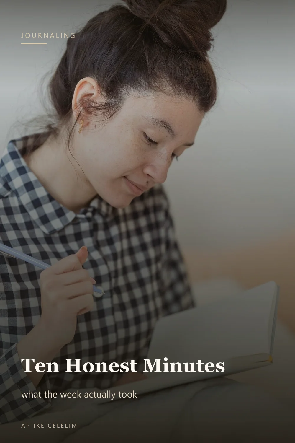 A woman writing in a notebook indoors